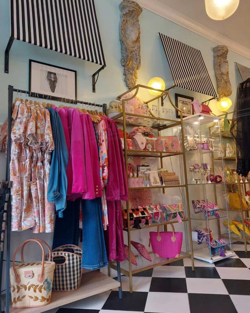 racks of clothing and shelves of merchandise at Muguette Renee