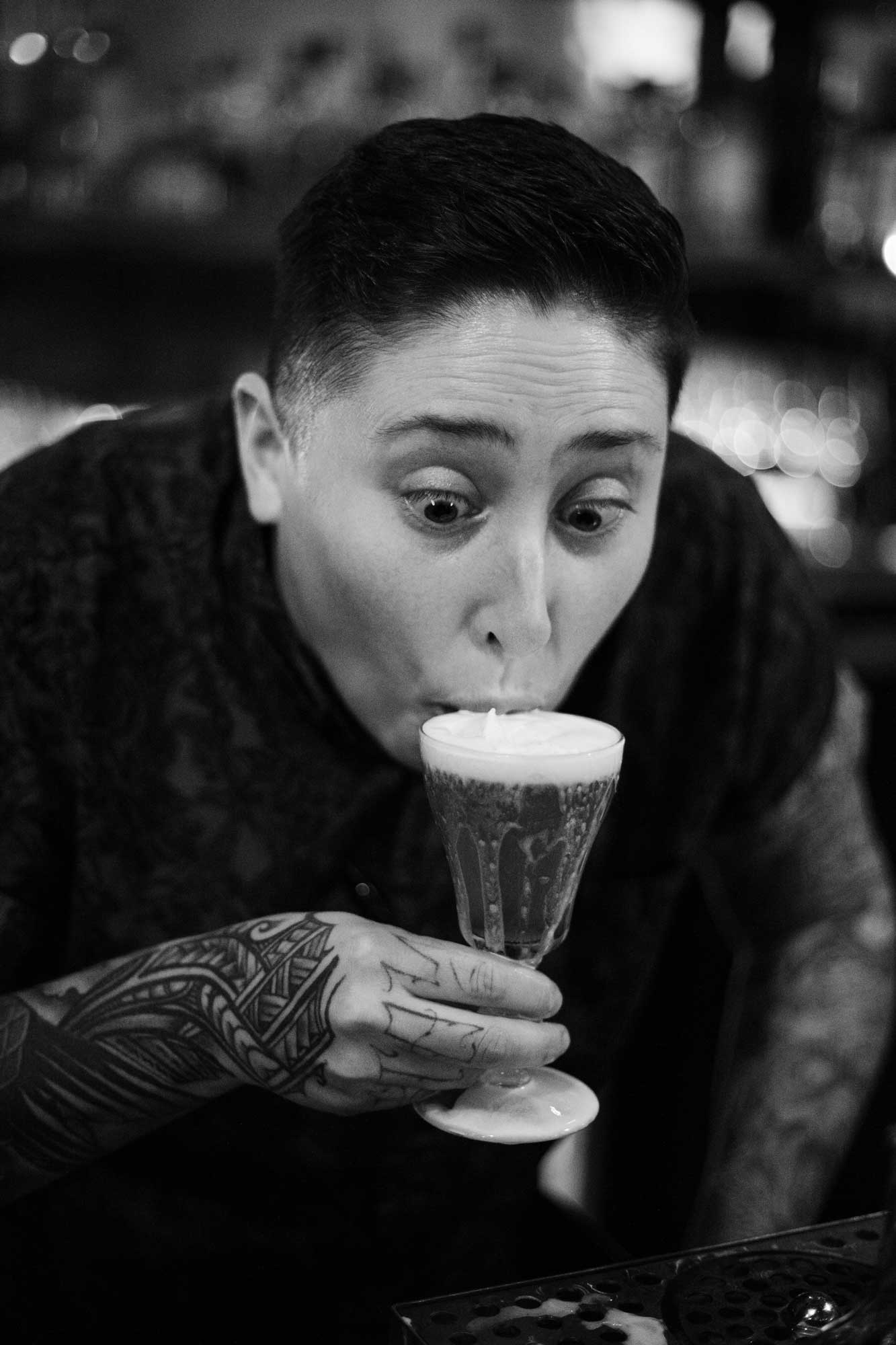 person sipping foam of a beer, wide-eyed