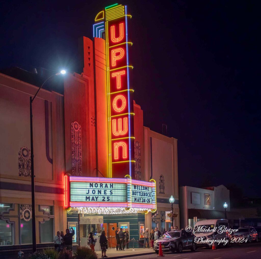 exterior of Uptown Theatre at night with marquee lighted